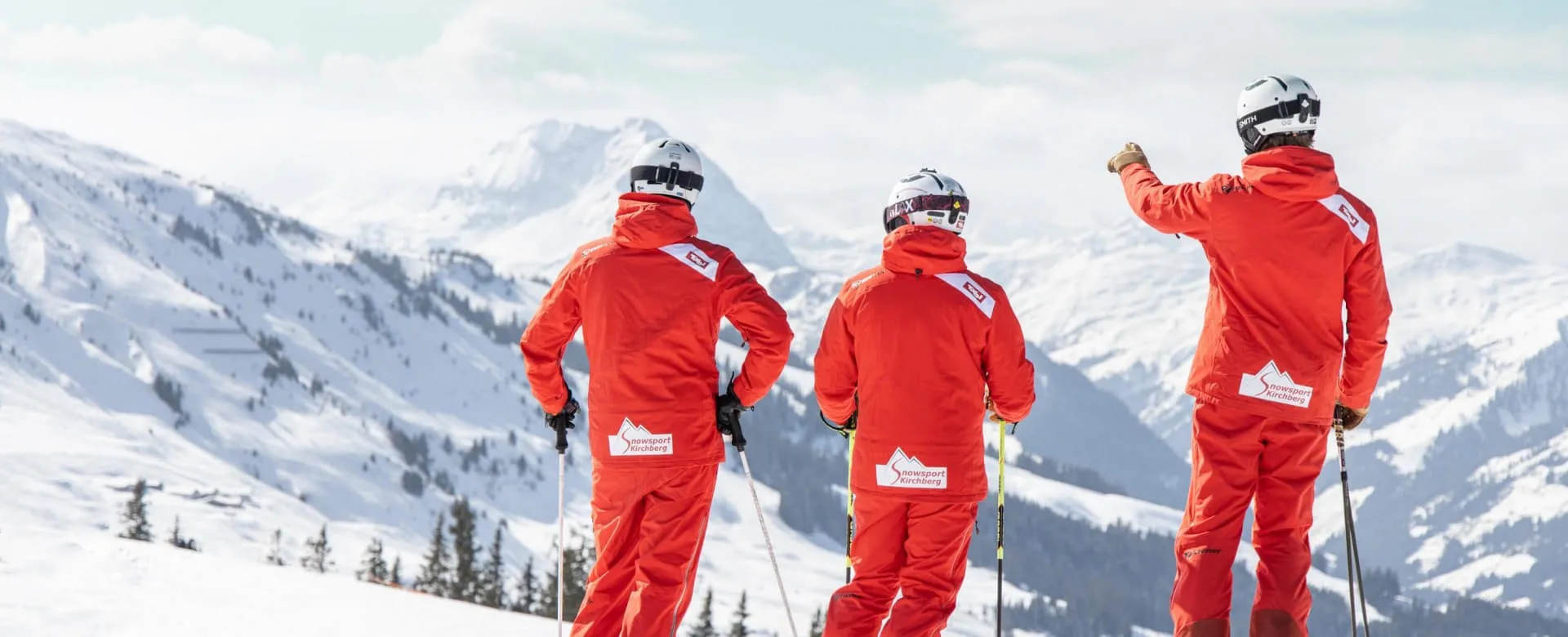Drei Skifahrer in roten Anzügen in Kirchberg.